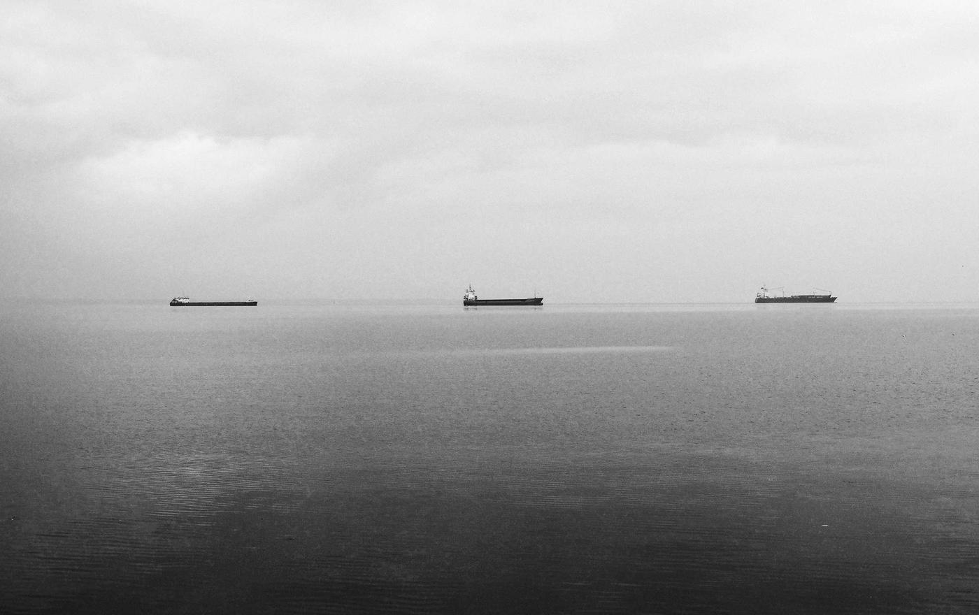 Cargo ships on a flat sea