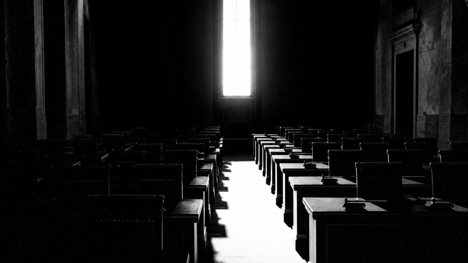Rows of empty seats in a darkened hall
